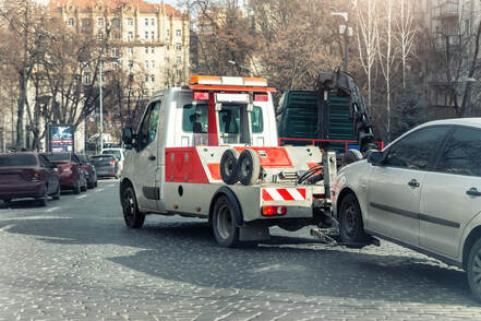 Accident vehicle being towed by a tow truck