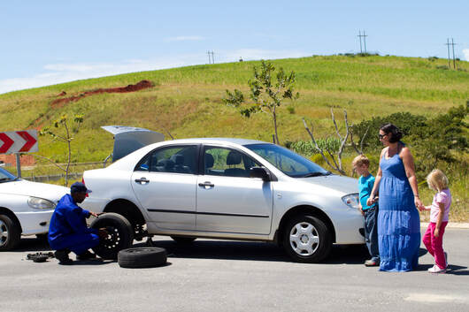 Roadside assistance changing a flat tire